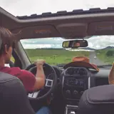 people in a car driving