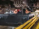 service tech working on vehicle